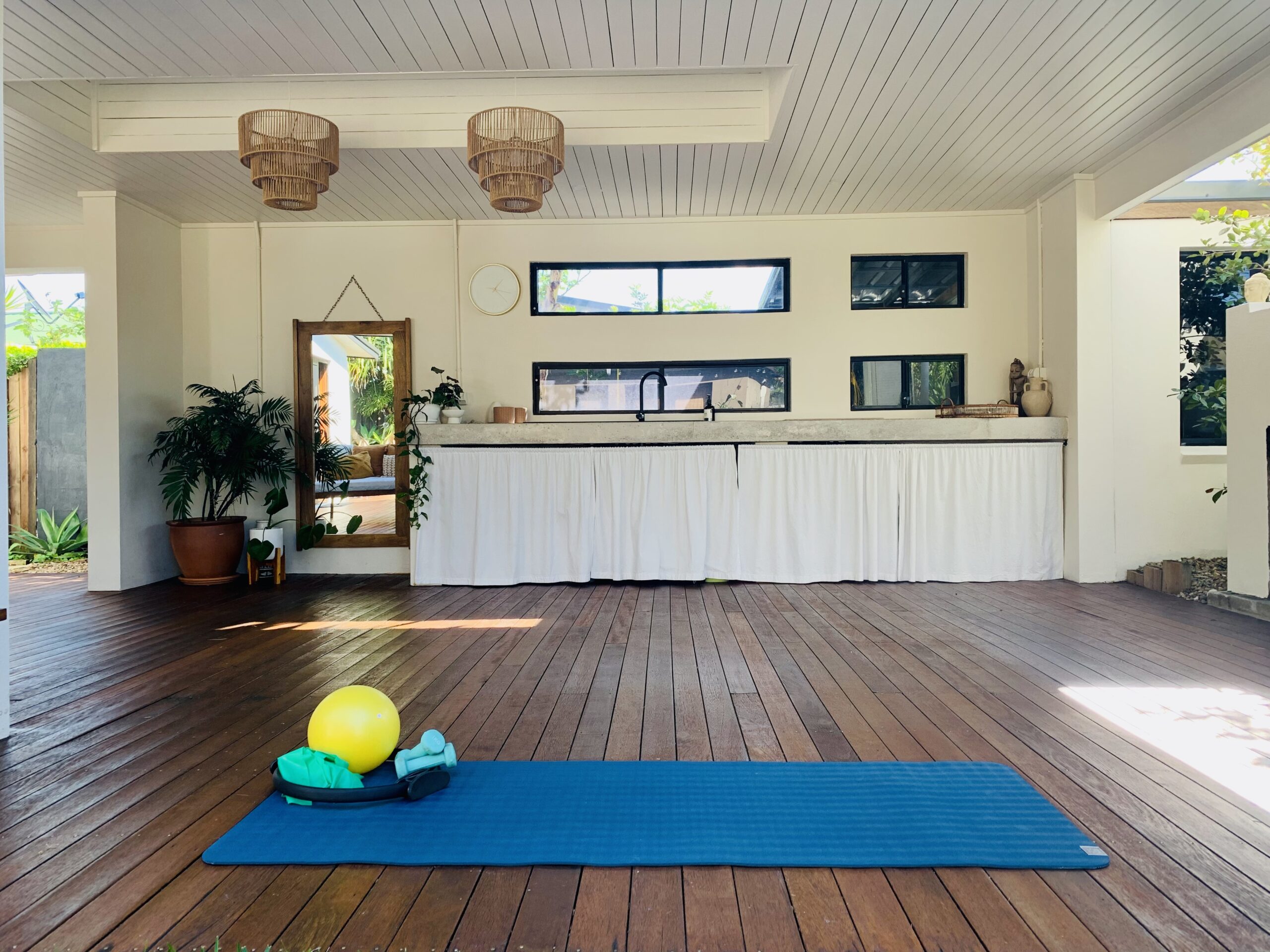Halo Pilates' shaded outdoor deck surrounded by tropical greenery in Wurtulla